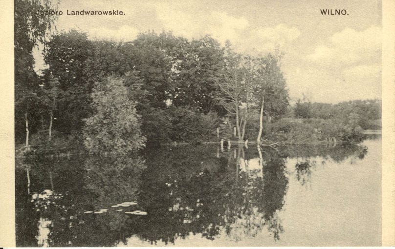 Lentvario ežeras senoje atvirutėje Sena atvirukinė nuotrauka: ramus ežeras su medžių atspindžiais vandenyje, užrašai Jezioro Landwarowskie ir Wilno